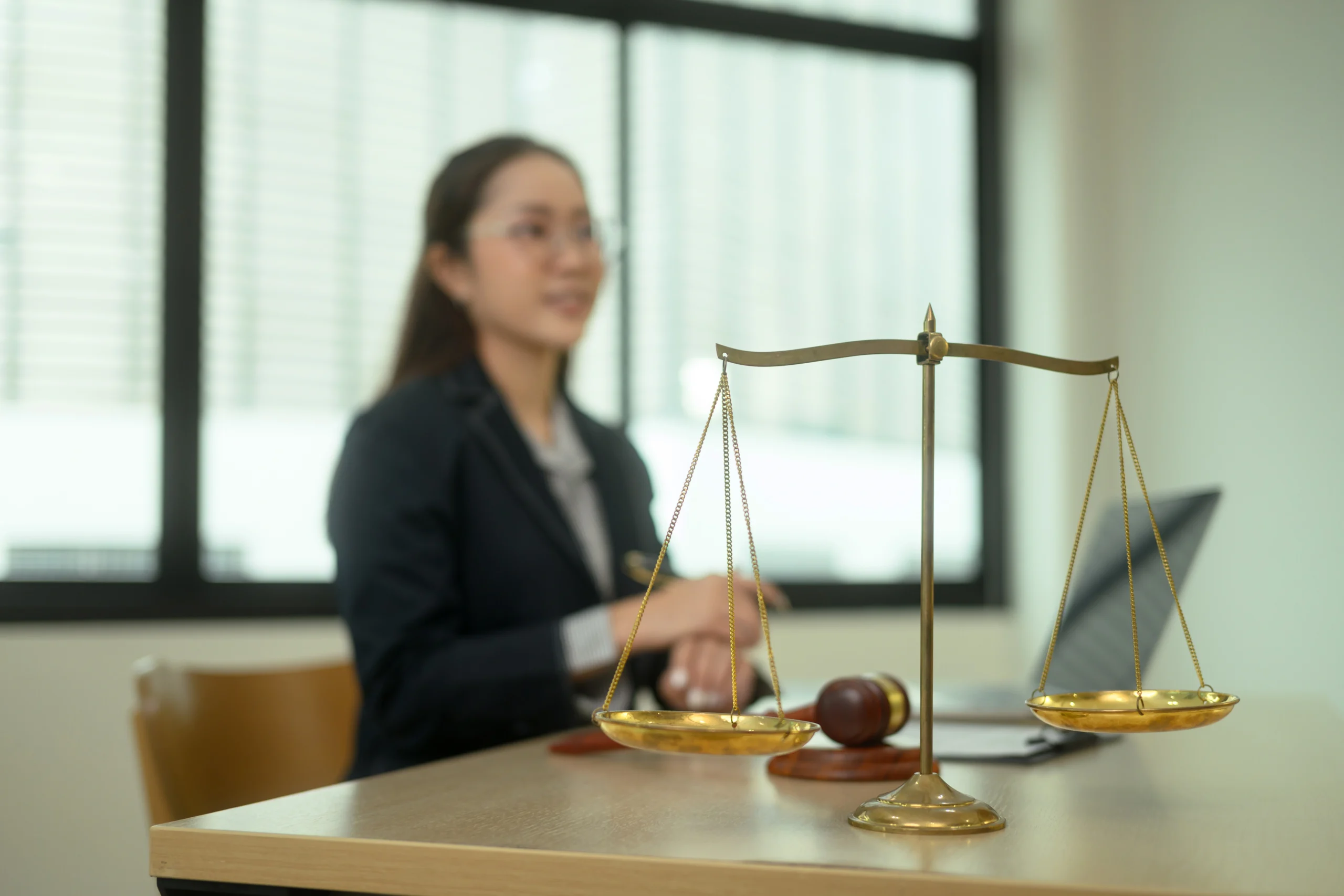 golden balance scales on wooden table against